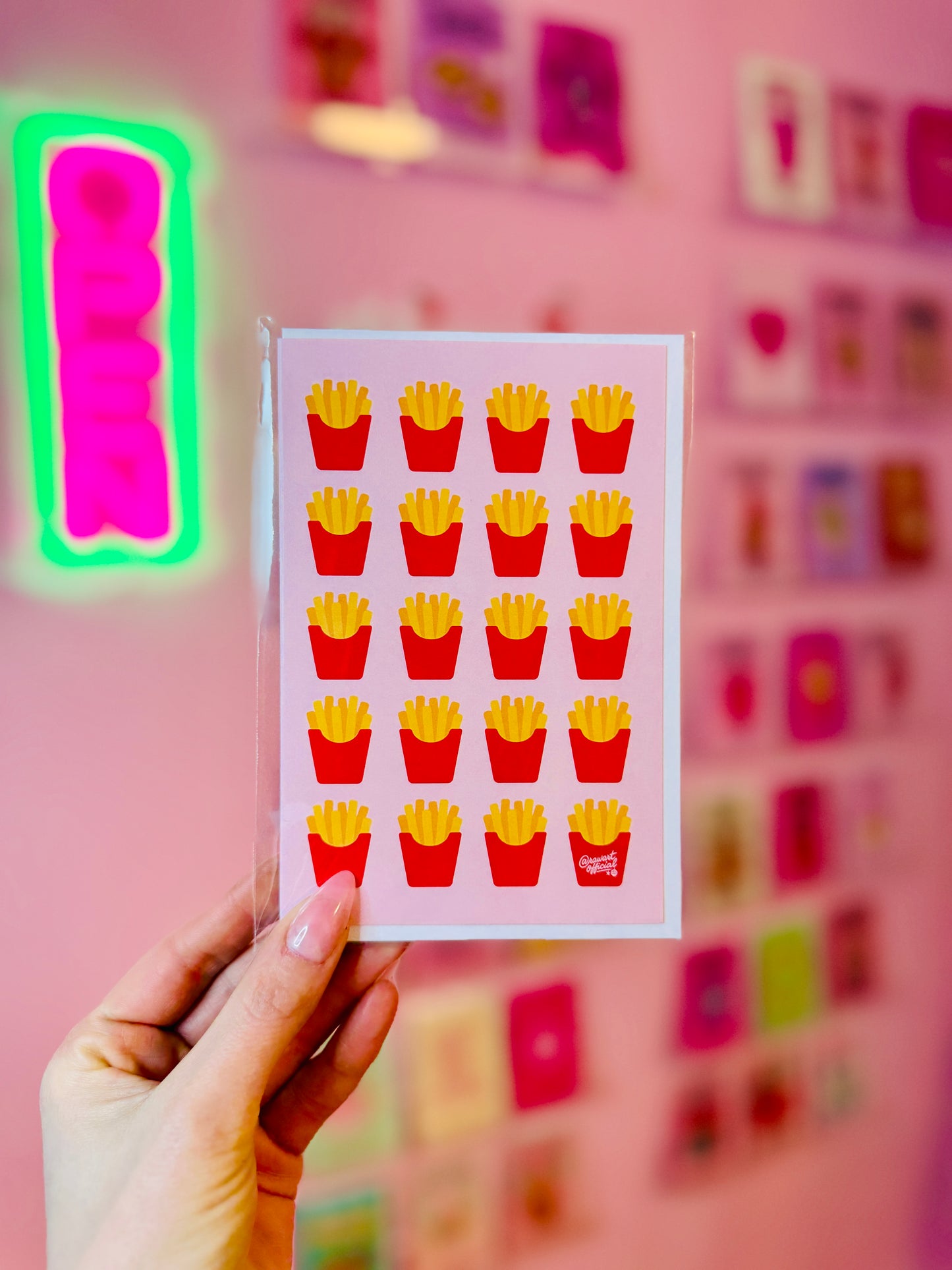 Greeting card featuring a repeating pattern of illustrated french fries in red cartons on a soft pink background.
