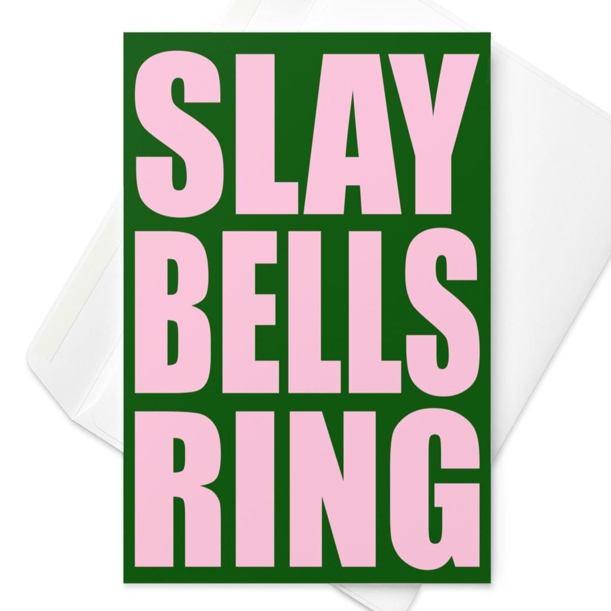Funny Christmas greeting card with bold pink text reading “Slay Bells Ring” on a dark green background in retro typography.