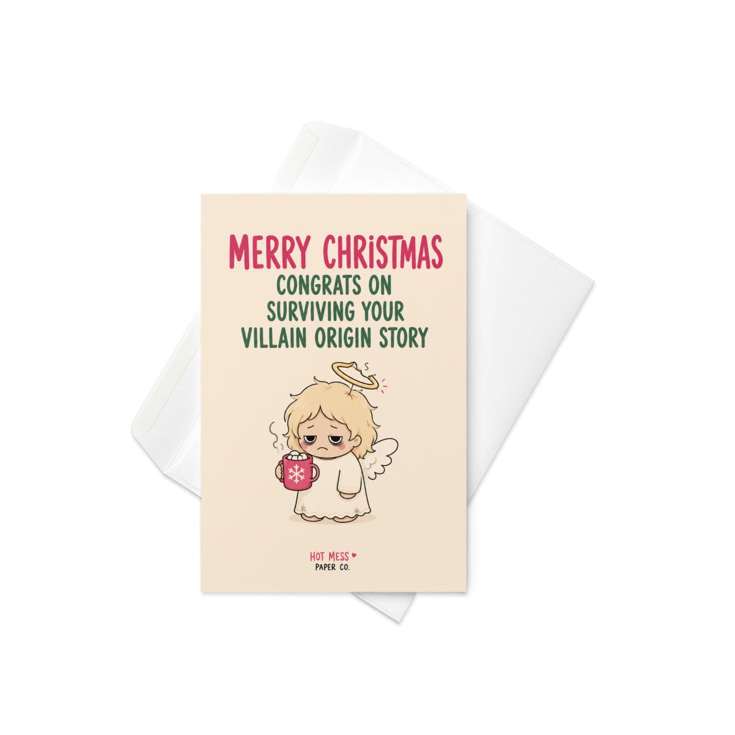 Funny Christmas card featuring a tired angel holding hot cocoa beside the phrase “Congrats On Surviving Your Villain Origin Story.”