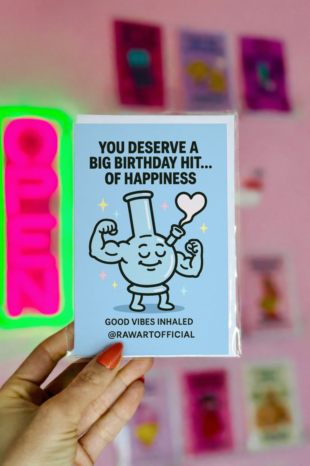 Buff cartoon bong flexing with heart-shaped smoke on a blue stoner birthday card by @rawartofficial.
