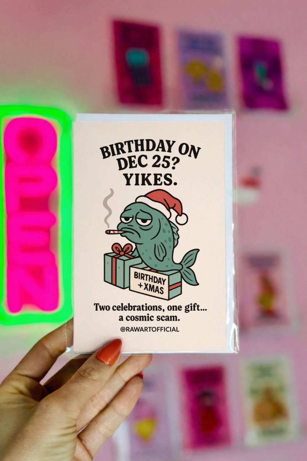 Funny Christmas birthday card with grumpy fish in Santa hat beside gift labeled “Birthday + Xmas” and text “Birthday on Dec 25 Yikes.”