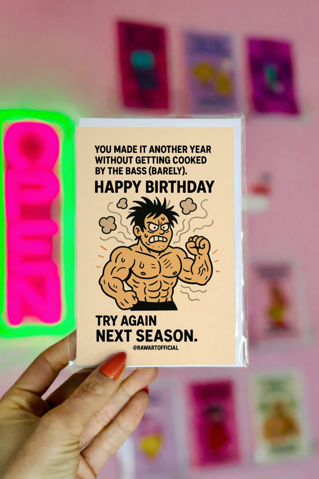 Buff cartoon raver character looking angry and smoky, with birthday text about surviving bass drops, in a humorous EDM-themed birthday card style.
