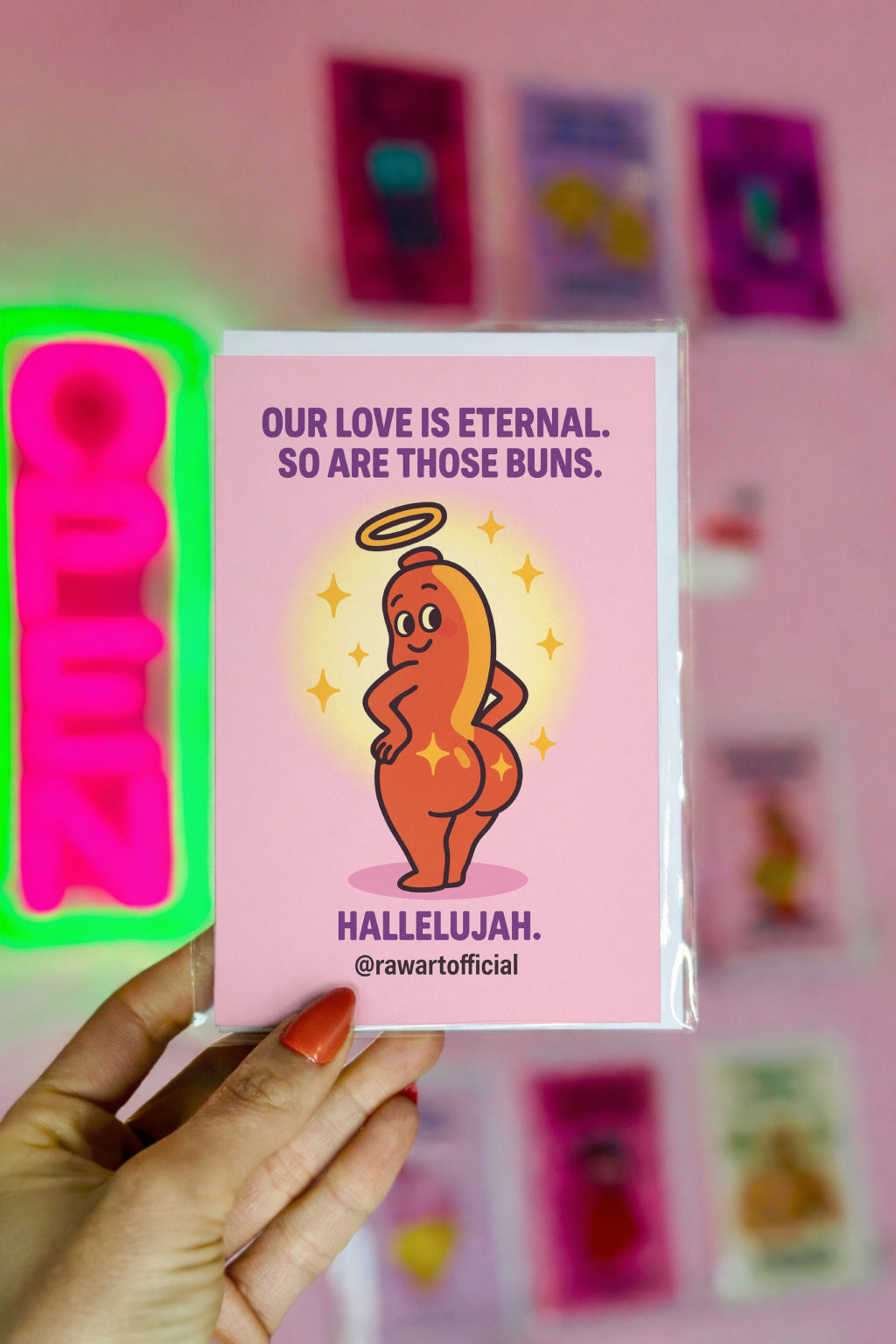 Cartoon angel hot dog showing off glowing buns with sparkles, humorous anniversary card by @rawartofficial.