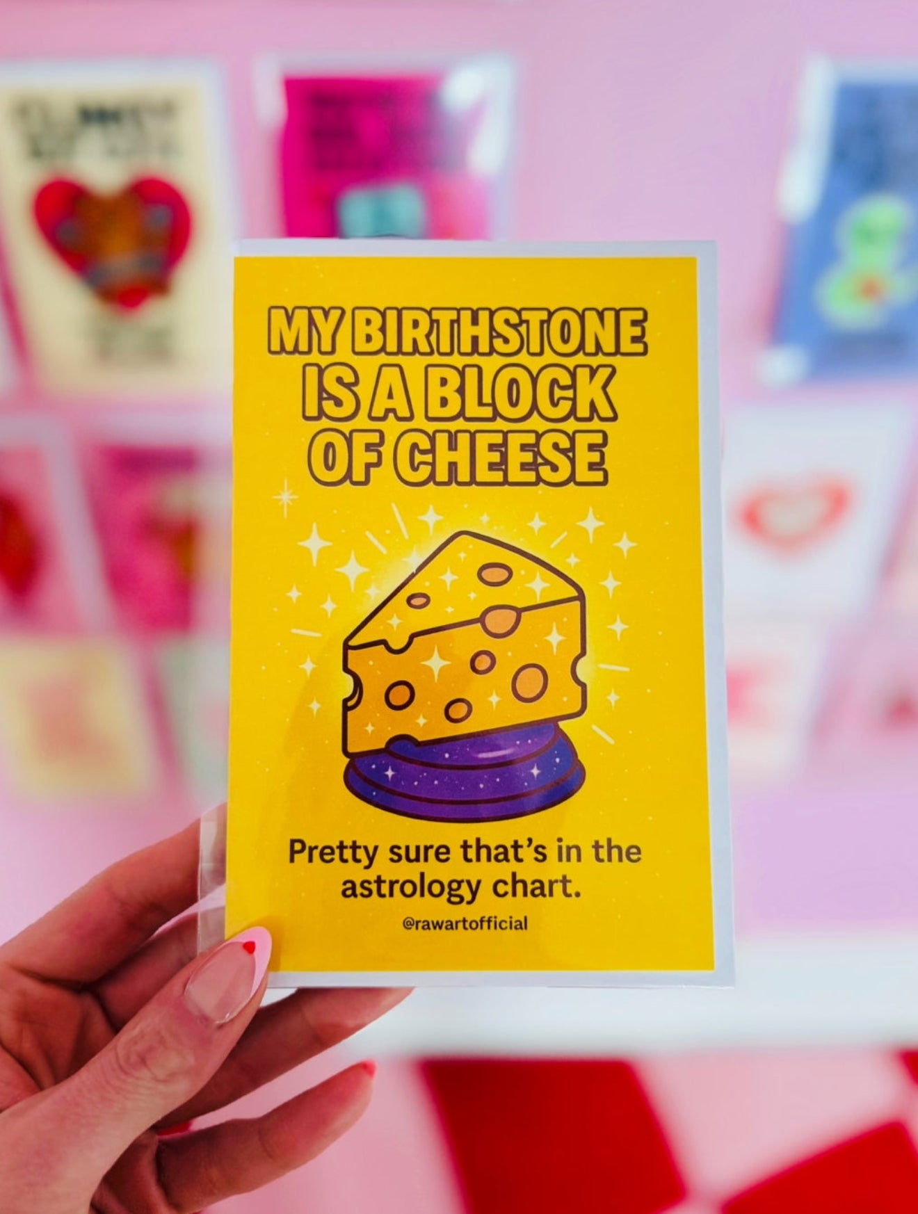Sparkly cartoon cheese wedge on yellow background with text “My Birthstone Is a Block of Cheese.”