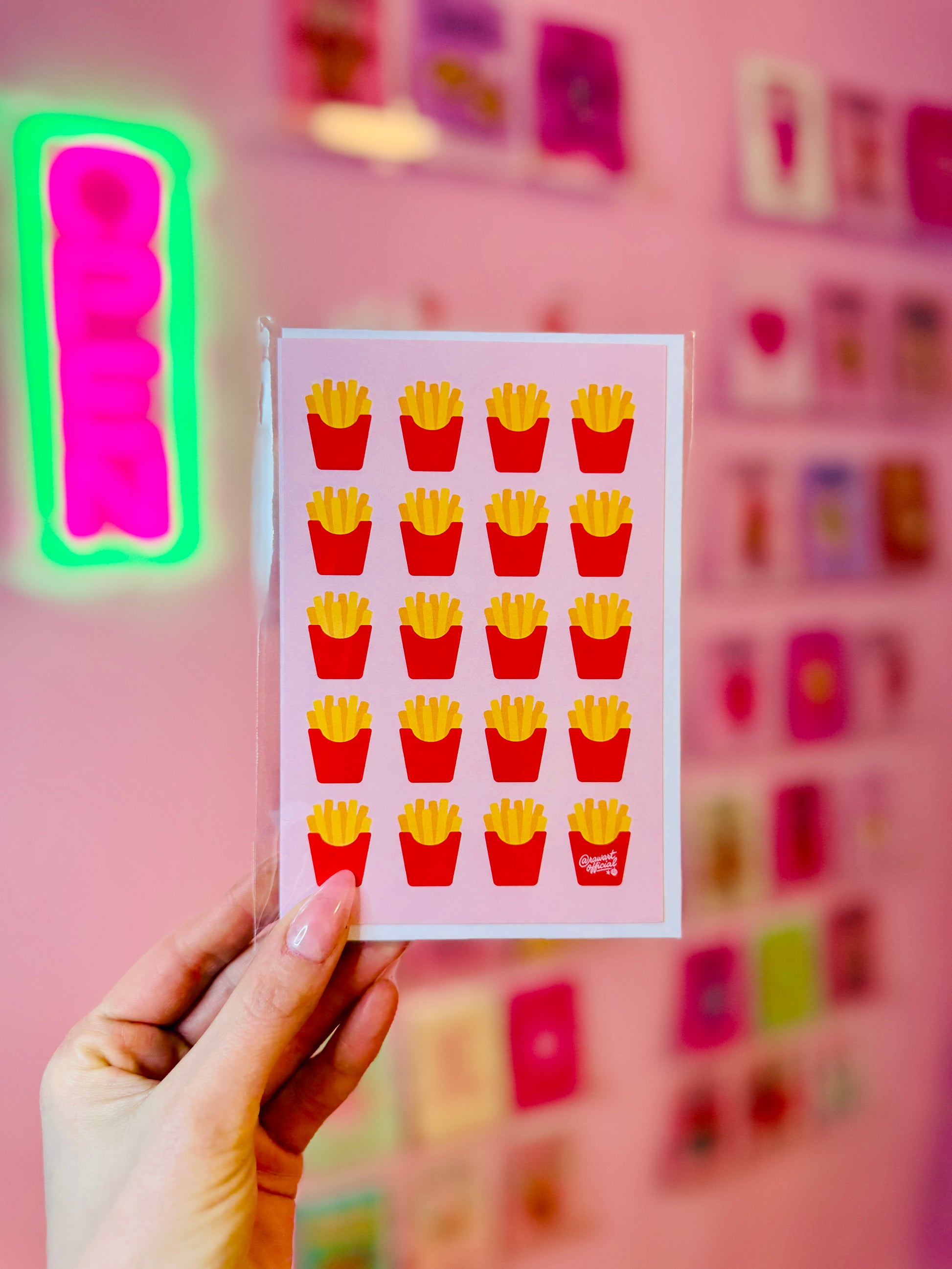 Greeting card featuring a repeating pattern of illustrated french fries in red cartons on a soft pink background.
