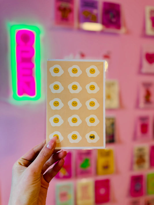 pink card with repeating cute smiley fried eggs breakfast pattern