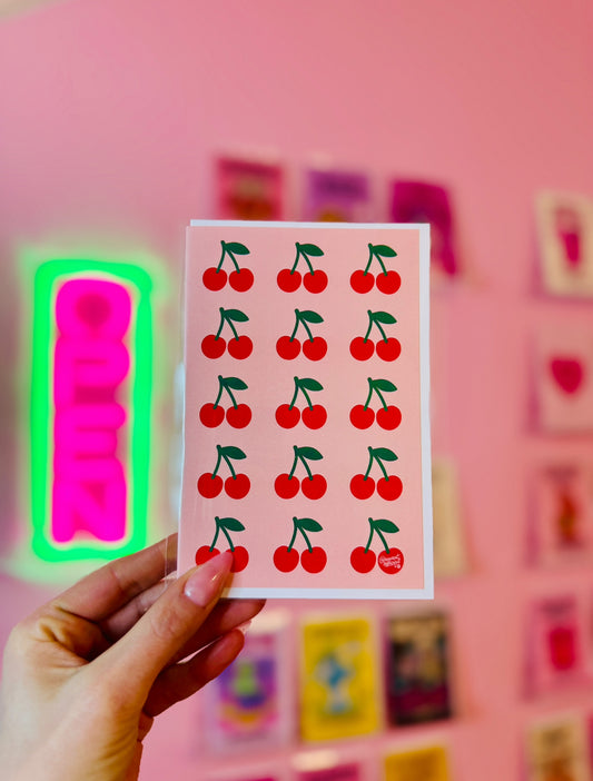 Cute cherry pattern card with rows of red cherries on a pink background retro fruit aesthetic design