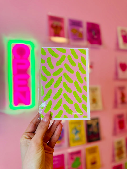 Retro pickle greeting card with bright pink background, fun food pun design, and playful pop art style