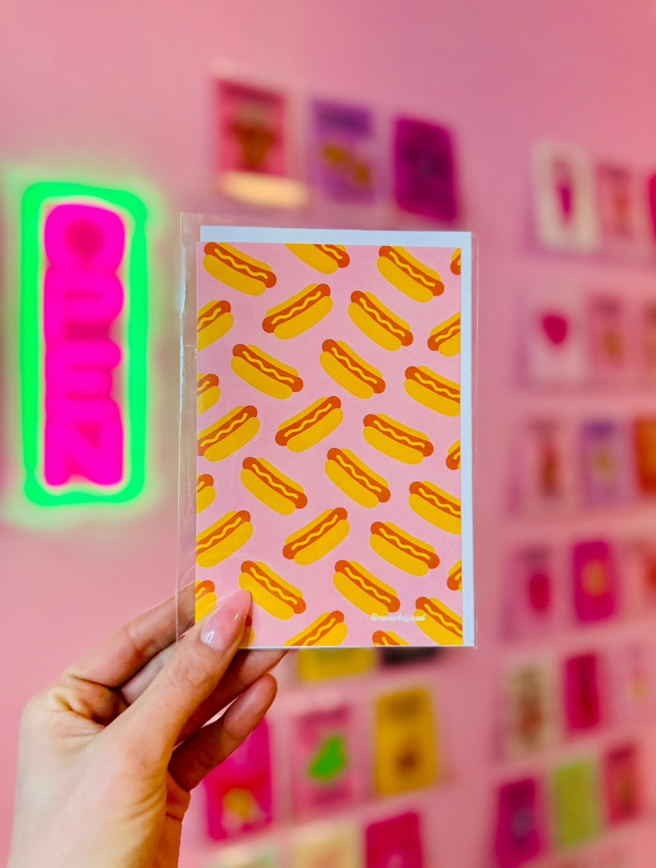 Retro hot dog pattern greeting card with playful pink background and bold orange-yellow hot dogs.