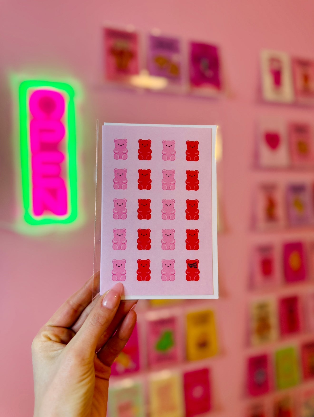 pink card with repeating pink and red gummy bears cute candy pattern design