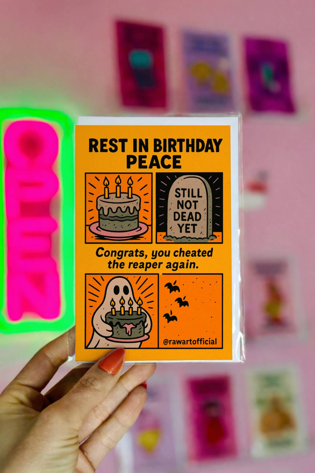 Funny dark humor birthday card featuring a cake, tombstone reading “Still Not Dead Yet,” and a ghost holding a birthday cake with the text “Rest In Birthday Peace.”