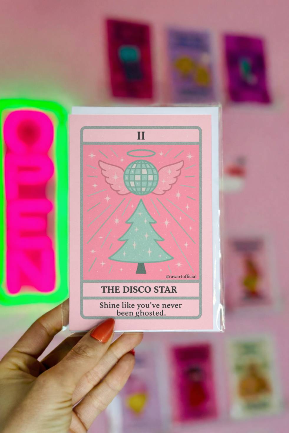 Tarot-style Christmas greeting featuring a winged disco ball above a Christmas tree titled “The Disco Star.”