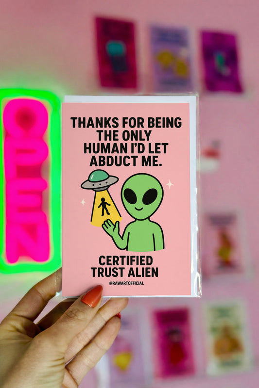 Green alien holding a UFO beam with a tiny human inside, text saying “Thanks for being the only human I’d let abduct me.”