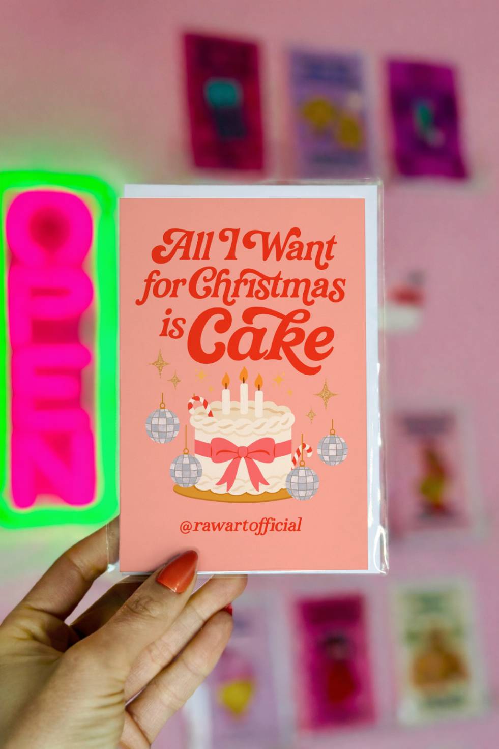 Funny Christmas greeting card featuring a festive holiday cake with candles and ornaments with the phrase “All I Want for Christmas Is Cake.”