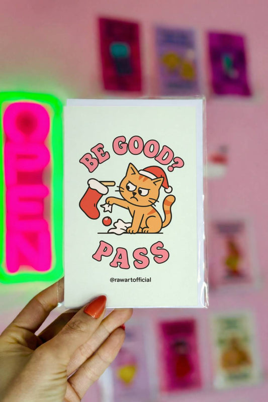Funny Christmas card with orange cat wearing Santa hat knocking ornaments from a stocking with text “Be Good? Pass.”