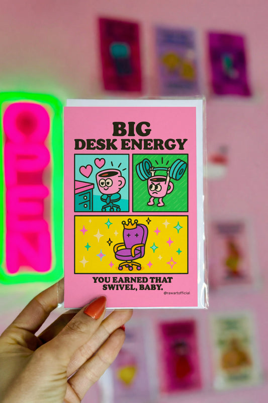 Retro cartoon coffee mug lifting weights and loving a pink desk beside a crown swivel chair — “Big Desk Energy” card by @rawartofficial.