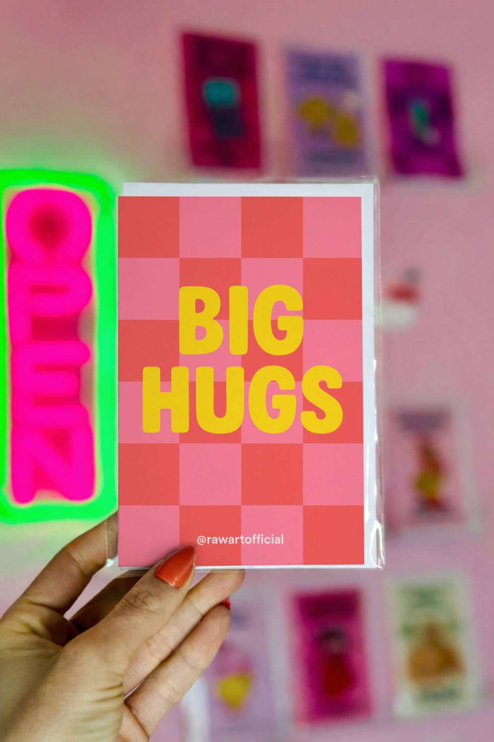 Greeting card with yellow “BIG HUGS” text on a pink gingham background.