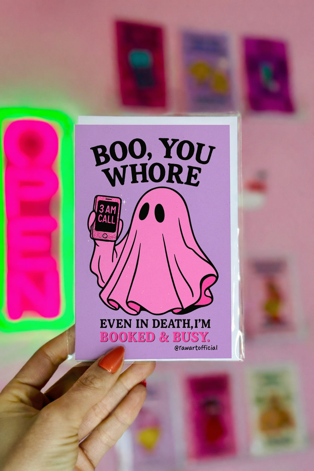 Pink ghost Halloween card saying “Boo You Whore” with a spooky cute vibe, holding a glittery 3AM call phone.