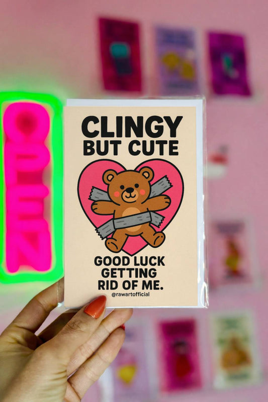Cartoon teddy bear duct-taped to a pink heart with text “Clingy But Cute – Good luck getting rid of me.” Funny Love card design.