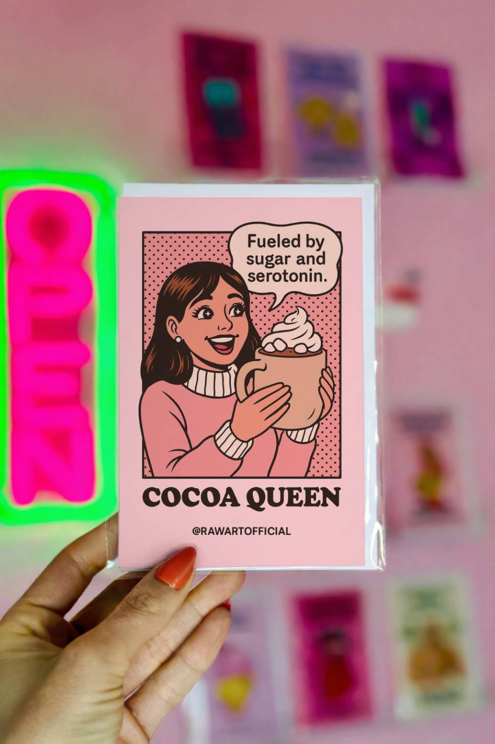 Funny Christmas greeting card featuring a retro comic-style woman holding a large mug of hot cocoa with whipped cream and the text “Cocoa Queen.”