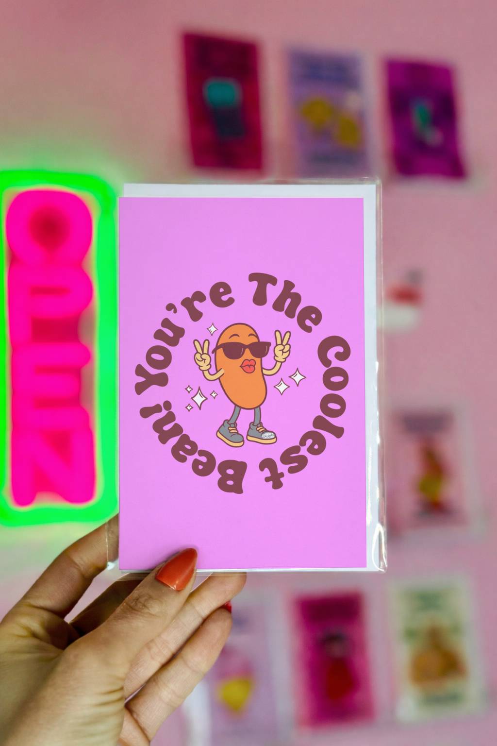 Purple birthday card featuring cartoon bean in sunglasses with text “You’re the Coolest Bean.”