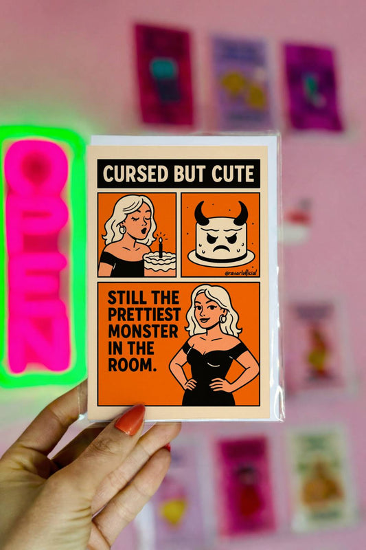 Retro goth birthday card with blonde monster girl and cursed cake, text "Cursed But Cute"
