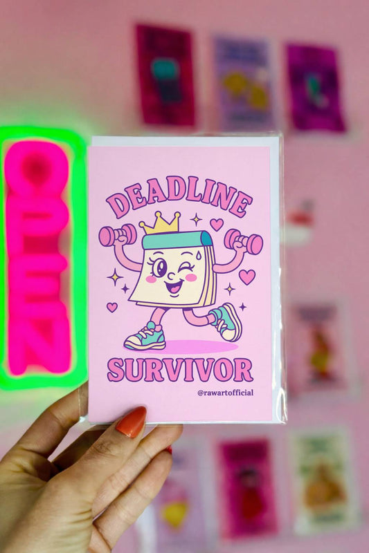Greeting card featuring a cartoon notepad character lifting dumbbells with the text “Deadline Survivor” on a pink background.