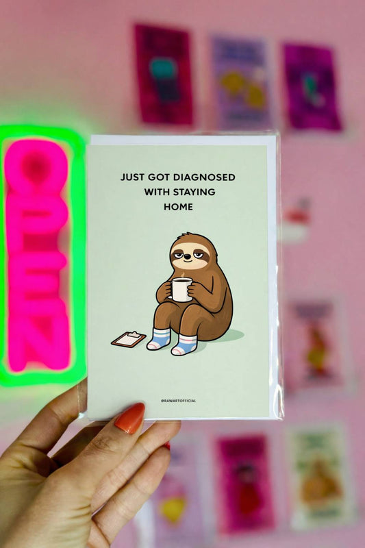 funny staying home greeting card with sloth wearing socks holding a mug and text just got diagnosed with staying home