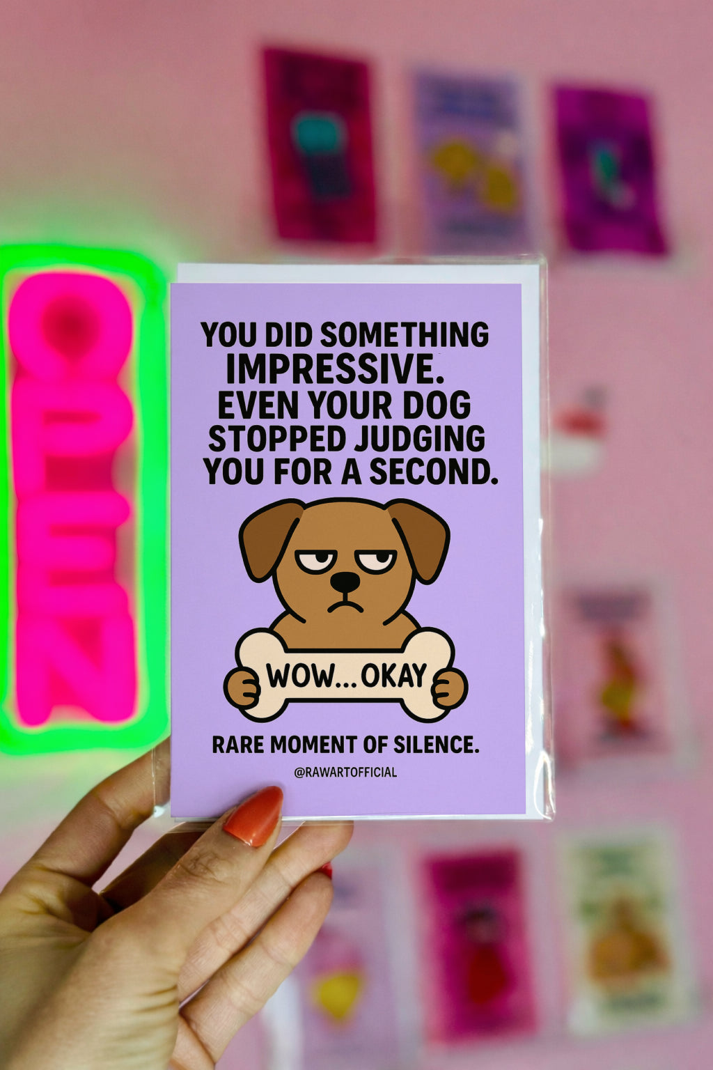Funny lavender greeting card with a grumpy cartoon dog holding a bone labeled “WOW… OKAY” and bold text about the dog stopping judgment for one second.