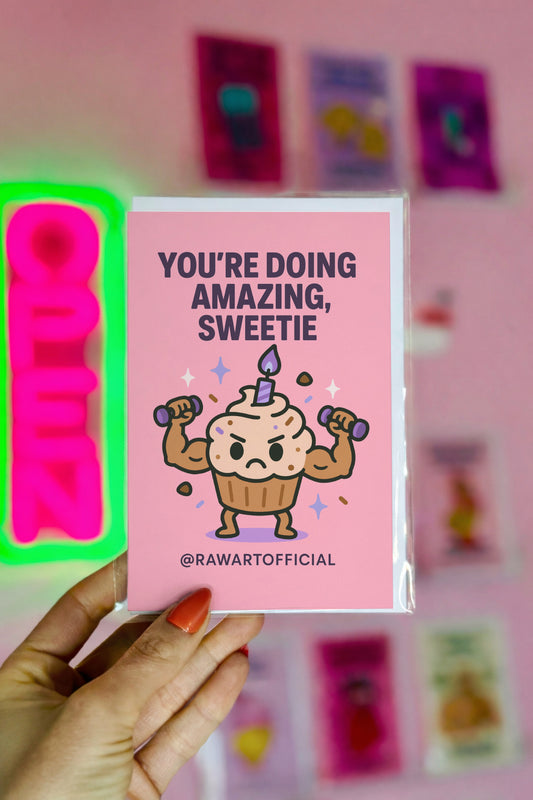 Cute pink card with a buff cupcake lifting dumbbells under the text “You’re Doing Amazing, Sweetie.”