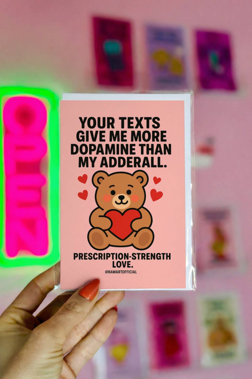 Funny greeting card reading “Your Texts Give Me More Dopamine Than My Adderall” with a teddy bear holding a heart on a pink background.