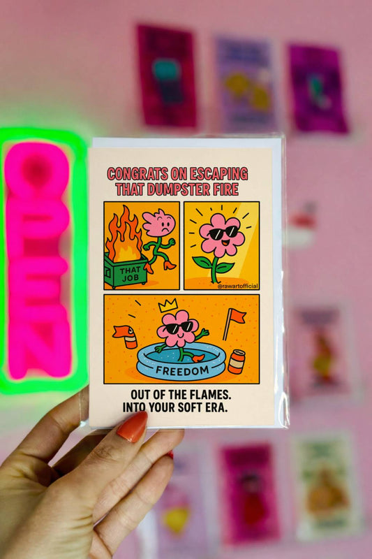 Funny celebration greeting card with comic panels of a flower character escaping a flaming dumpster labeled “That Job,” relaxing in a kiddie pool labeled “Freedom,” and wearing sunglasses. Caption reads: “Congrats on escaping that dumpster fire. Out of the flames. Into your soft era.”