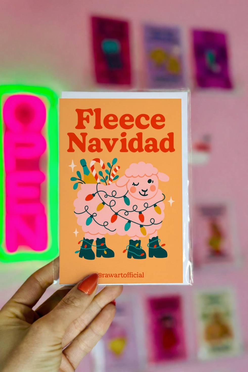 Funny Christmas greeting card with sheep wrapped in Christmas lights and text “Fleece Navidad.”