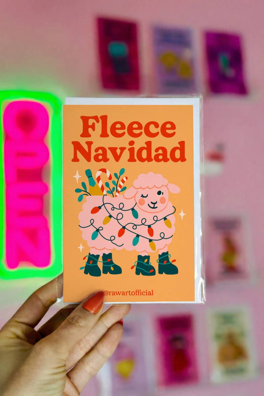 Funny Christmas greeting card with sheep wrapped in Christmas lights and text “Fleece Navidad.”