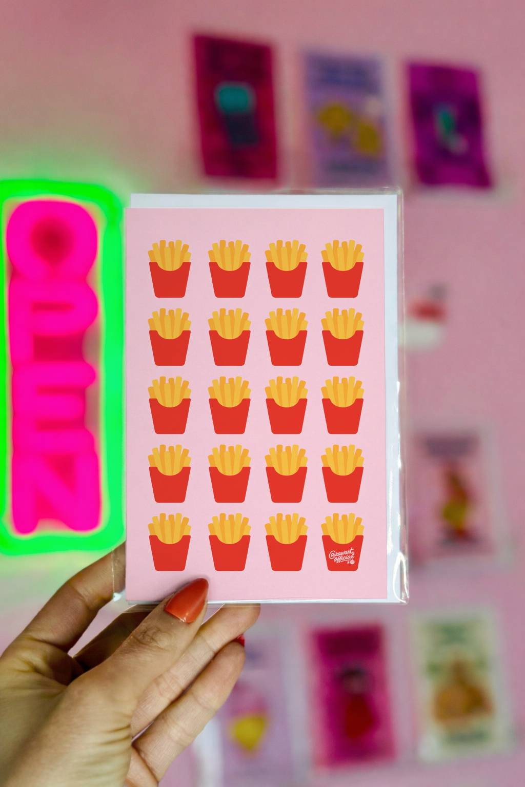 Greeting card featuring a repeating pattern of illustrated french fries in red cartons on a soft pink background.