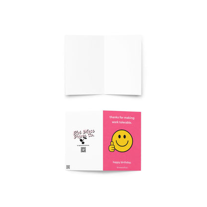 Funny coworker birthday card with smiley face giving thumbs up and text thanks for making work tolerable pink office humor design