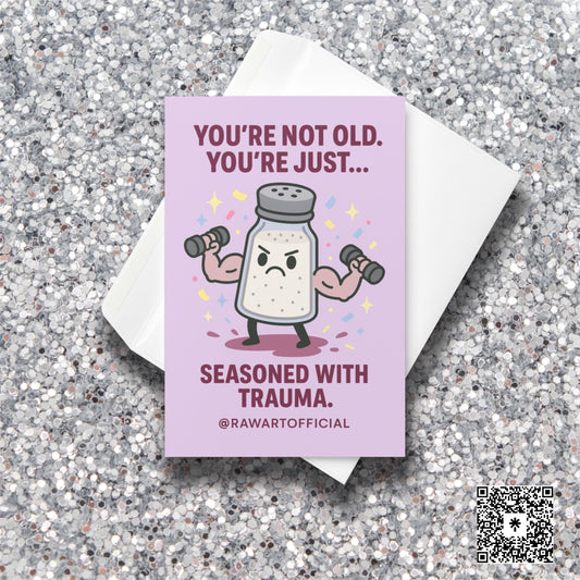 Buff salt shaker lifting weights with confetti and text: “You’re not old, just seasoned with trauma.”