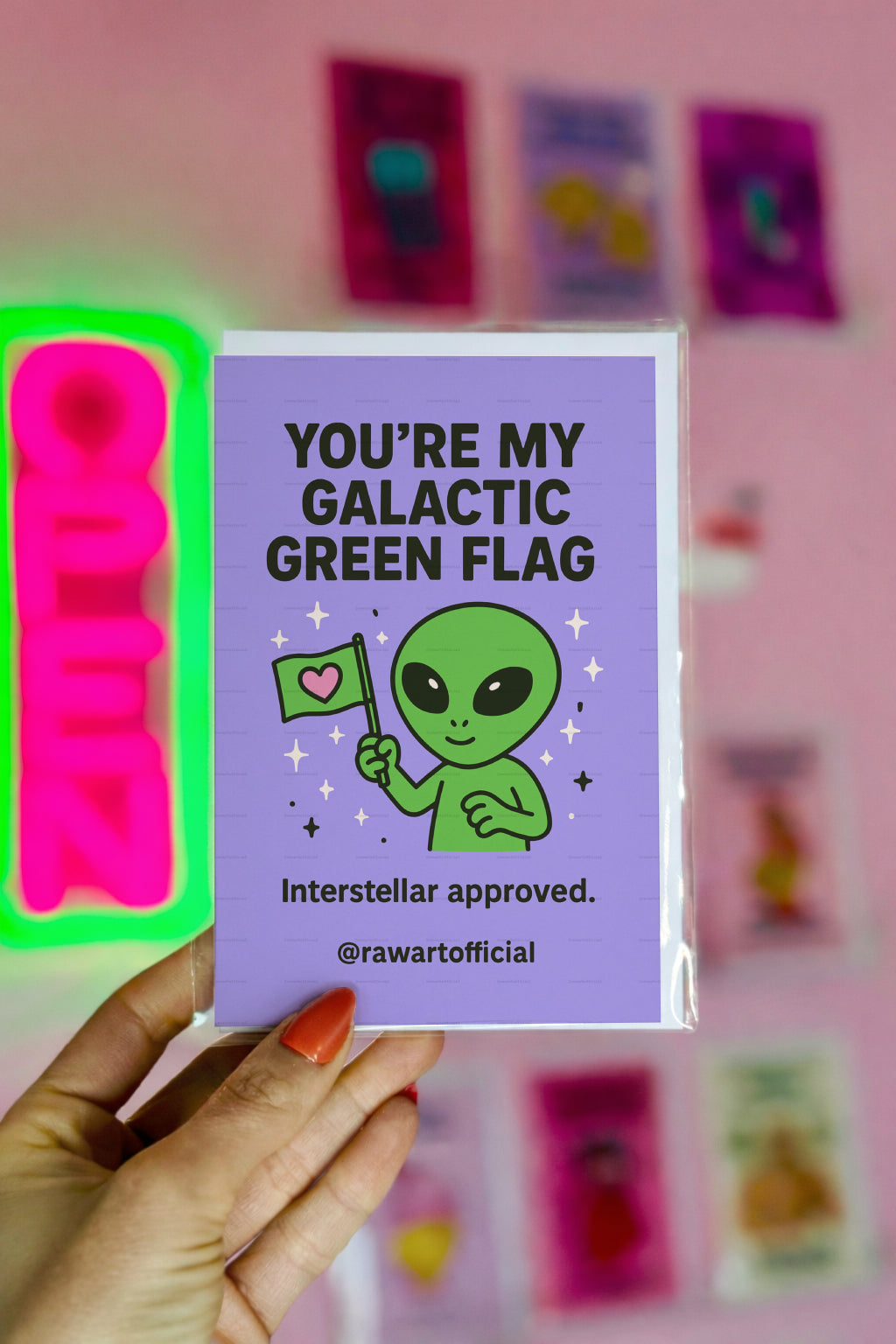 Green alien holding a heart flag with text “You’re My Galactic Green Flag.”