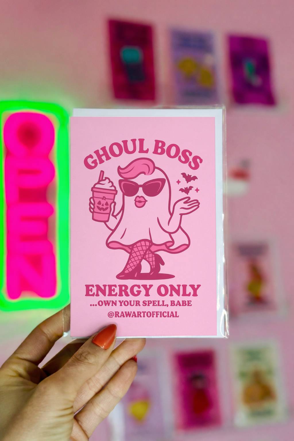Pink ghost in sunglasses and fishnets holding a pumpkin spice latte with bats flying, text reads “Ghoul Boss Energy Only.”