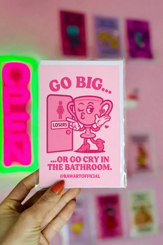 Greeting card featuring a cartoon trophy pointing at a door labeled “losers” with the text “Go Big… Or Go Cry in the Bathroom.”