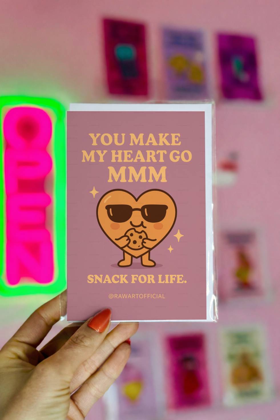 Greeting card with a heart wearing sunglasses eating a cookie with text “You Make My Heart Go MMM.”