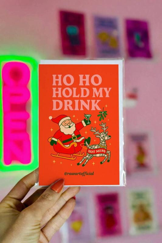 Funny Christmas greeting card featuring Santa holding a cocktail in a sleigh with a reindeer labeled hot mess and the phrase “Ho Ho Hold My Drink.”