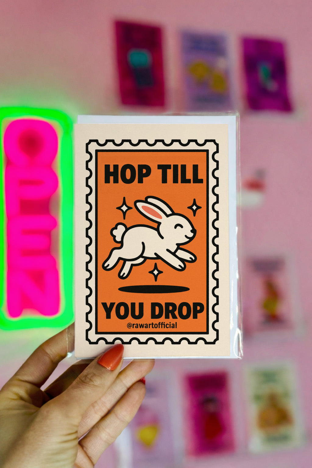 retro easter card with jumping white bunny and text hop till you drop inside postage stamp frame