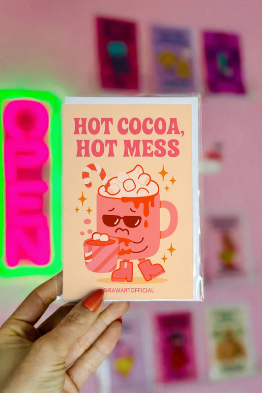 Funny Christmas greeting card with spilled hot cocoa mug wearing sunglasses and text “Hot Cocoa Hot Mess.”