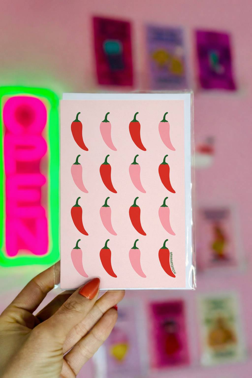 Funny greeting card with a repeating red and pink chili pepper pattern on a pastel background in a bold retro style