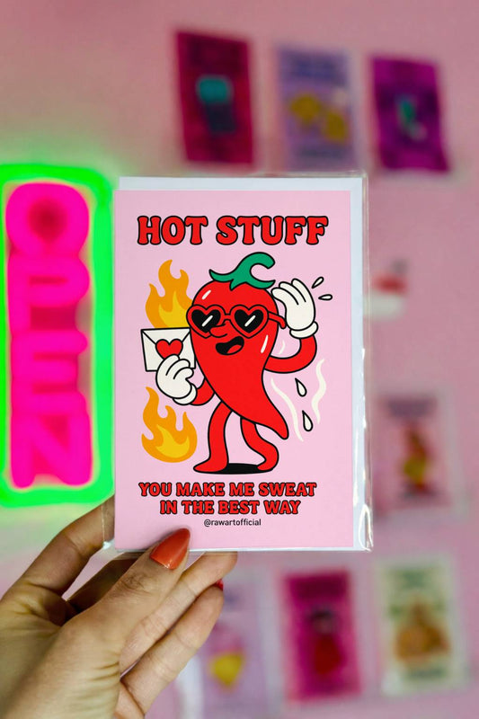 Funny Valentine card with a cartoon chili pepper wearing heart sunglasses and holding a love letter, captioned “Hot Stuff – You make me sweat in the best way.”