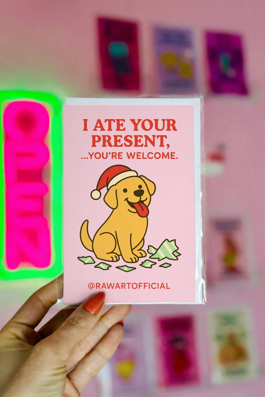 Funny Christmas card featuring a Labrador dog in a Santa hat sitting beside torn wrapping paper with text “I ate your present you’re welcome”