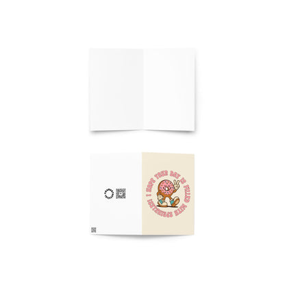 Cream birthday card featuring retro pink frosted donut with sprinkles flashing peace sign and circular birthday text.