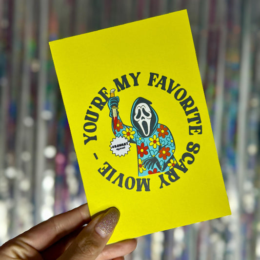 Retro Ghostface in colorful flower-print robe holding a knife, with text “You’re My Favorite Scary Movie” on bright yellow Halloween greeting card.