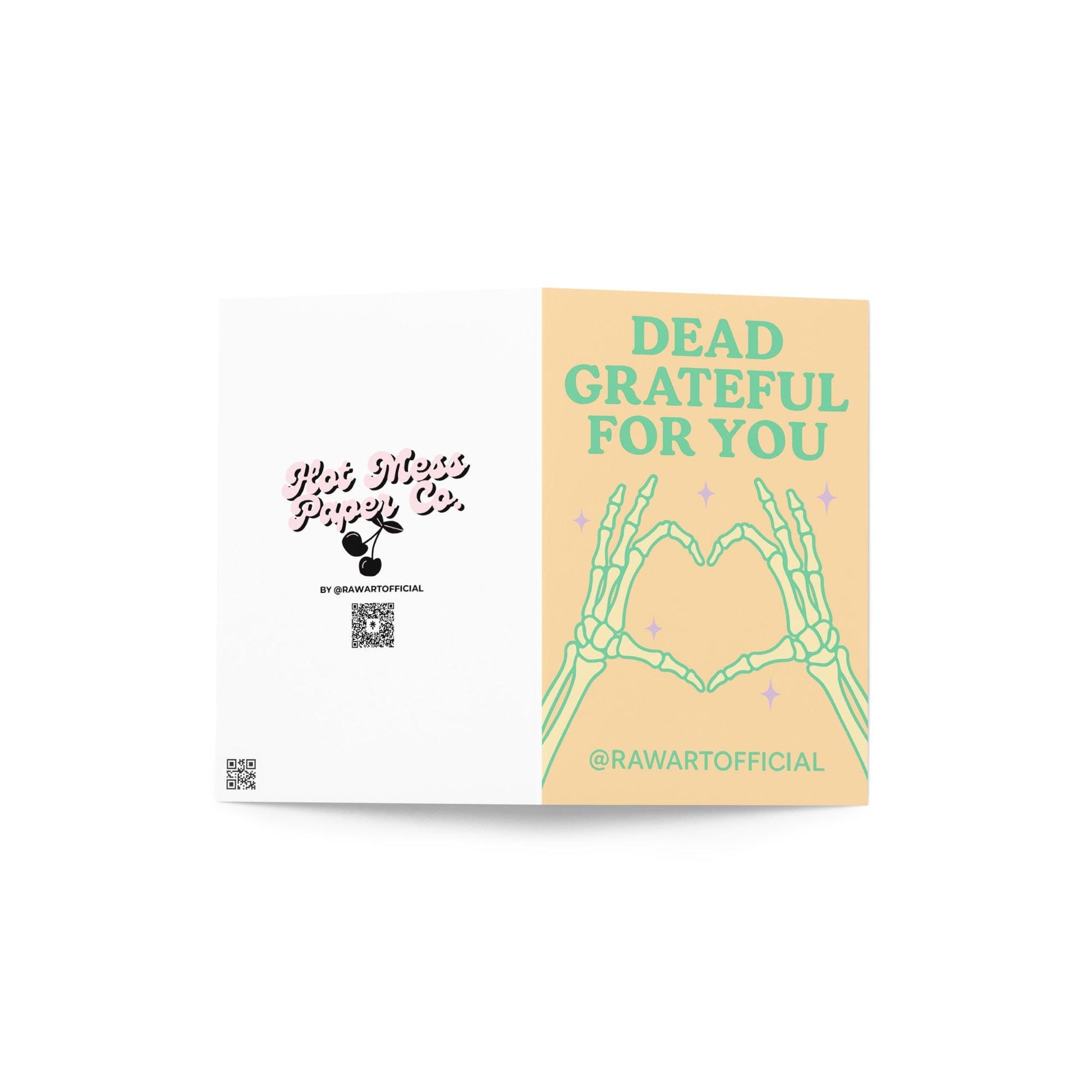 Greeting card with skeleton hands forming a heart and the text “Dead Grateful For You” in pastel green on a peach background.